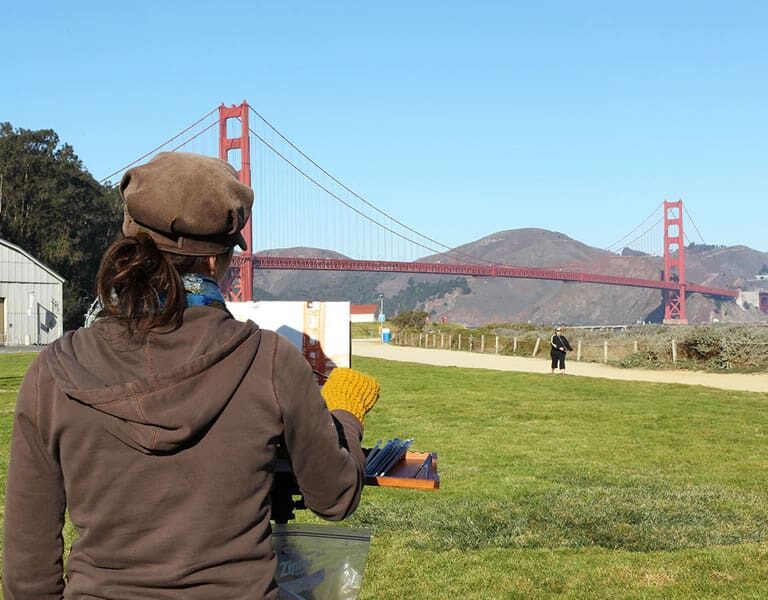 Student painting the Golden Gate Bridge