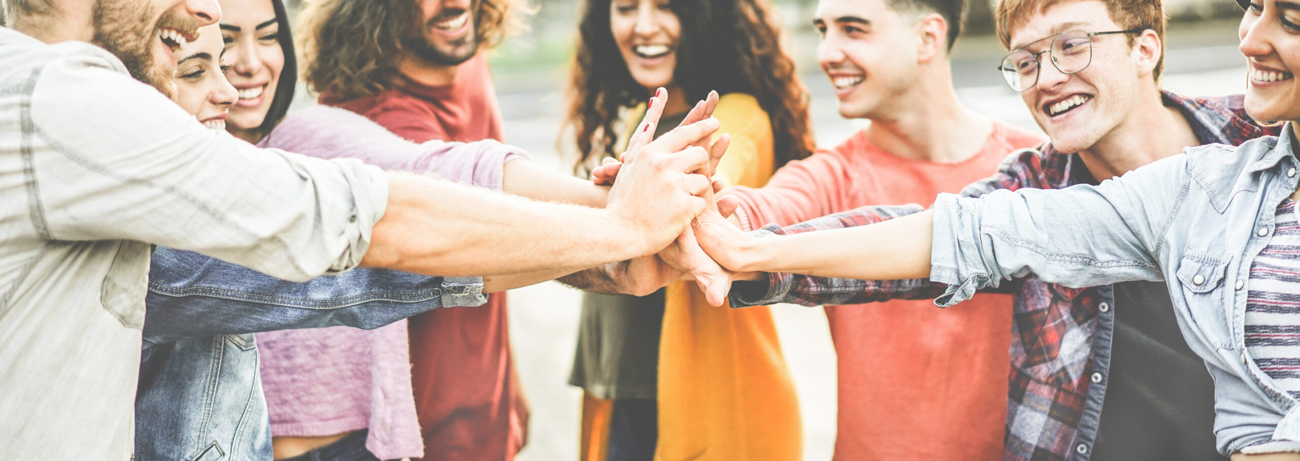 Group of young adults high fiving