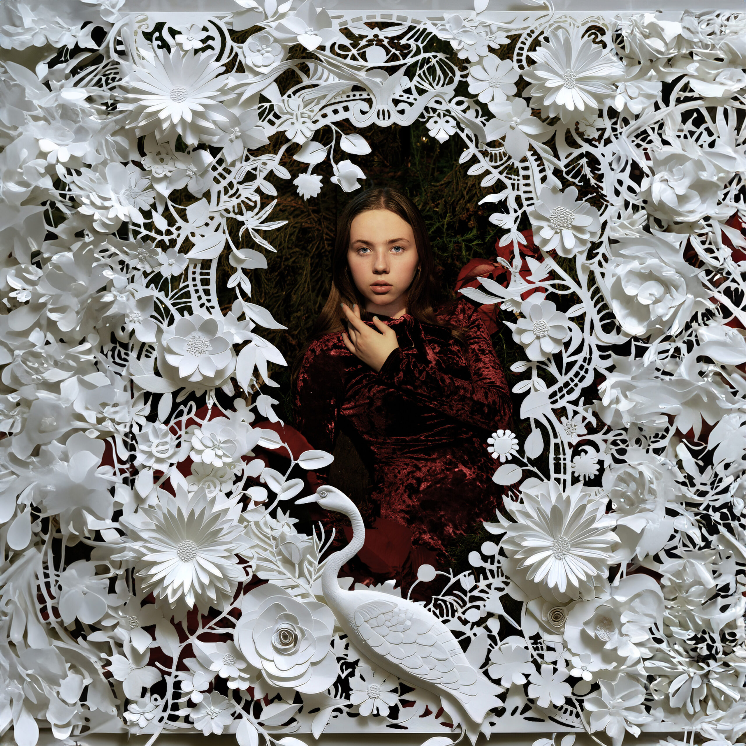 Image of woman dressed in red framed by paper cutout flowers