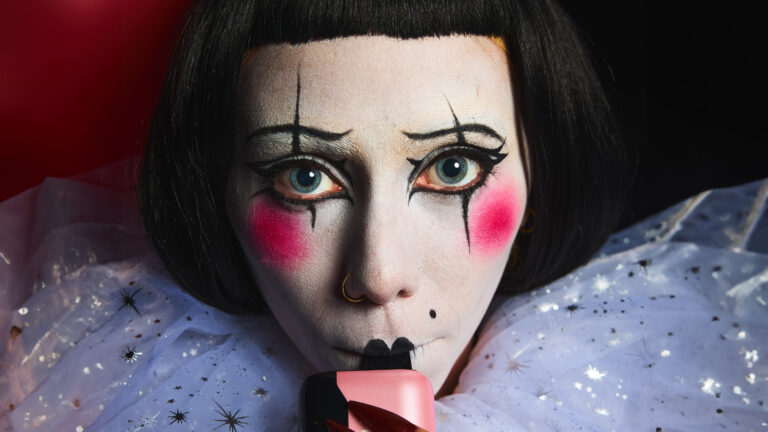 woman dressed as a clown vaping