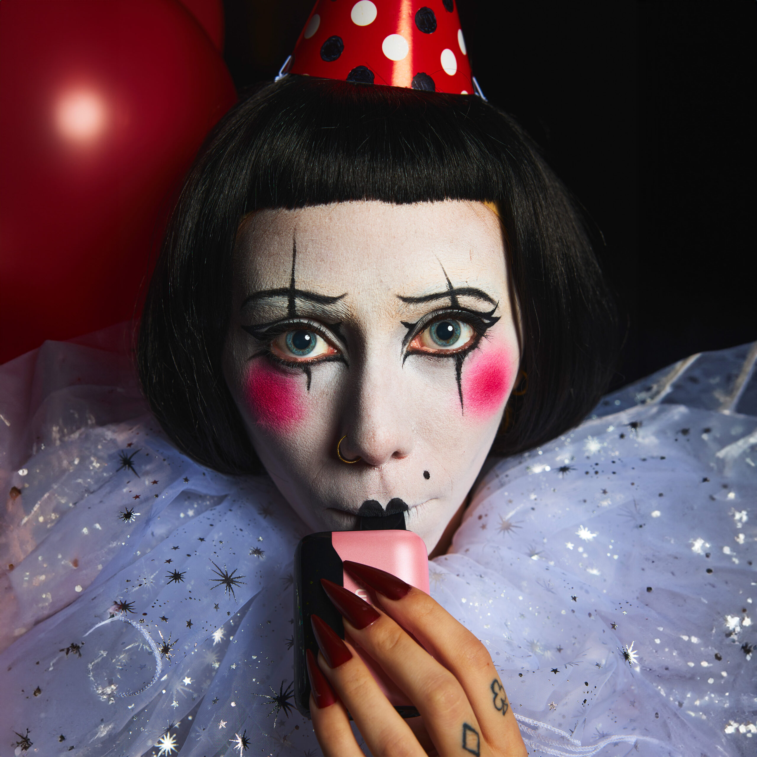 woman dressed as a clown vaping