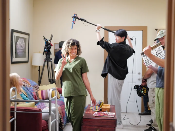 Student actors making a movie inside an apartment set