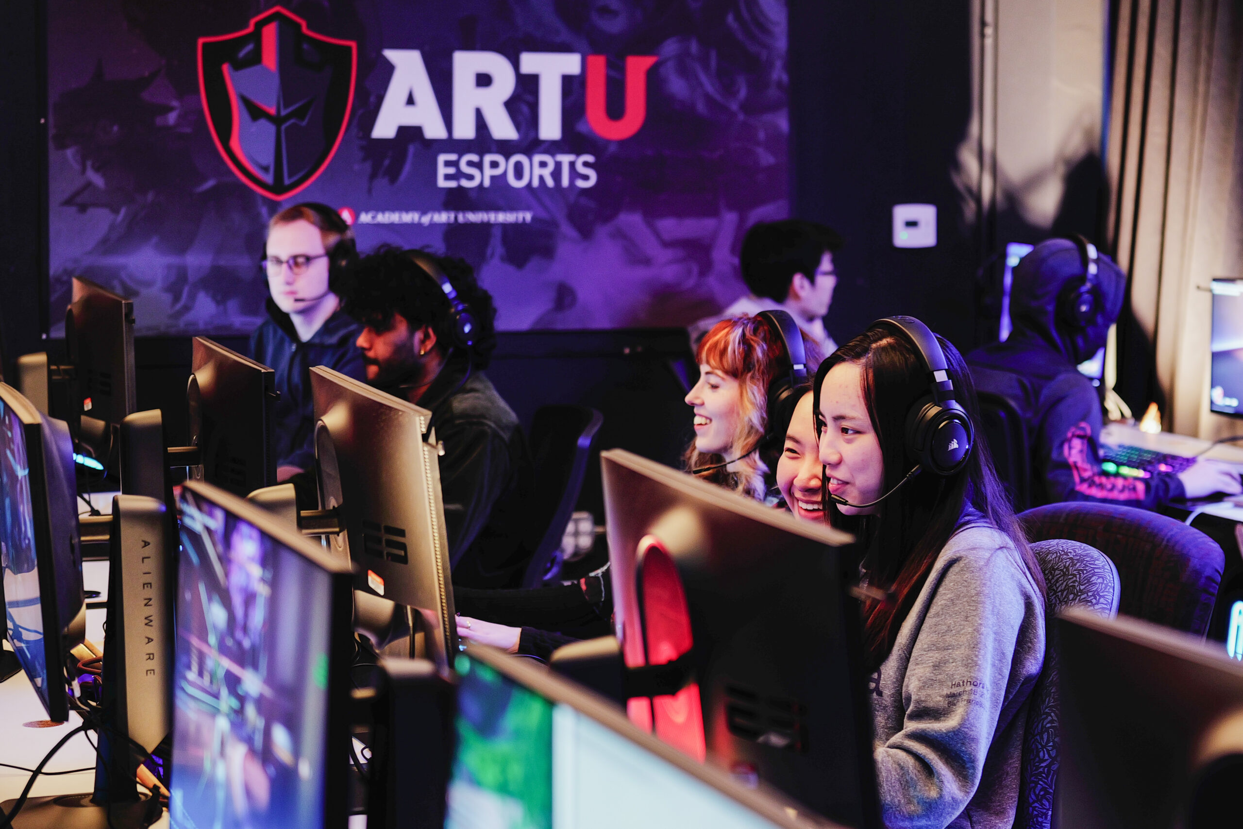 group of gamers playing in the Academy esports lounge