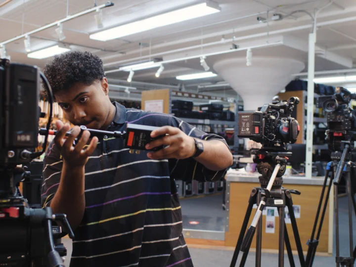 Student working on cameras in the Camera Room