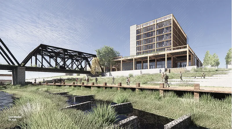 A modern, multi-story building stands beside a river, with people walking along a wooden boardwalk surrounded by grassy vegetation. A steel bridge spans the river. Text: “Cori Medley M Arch.”